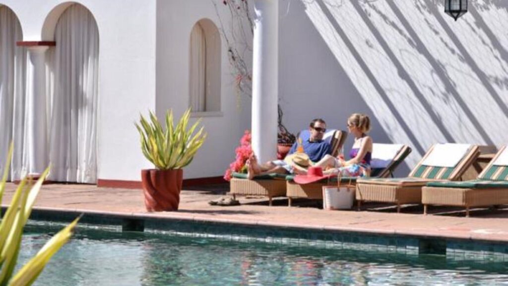 people-laying-by-victoria-falls-hotel-swimming-pool